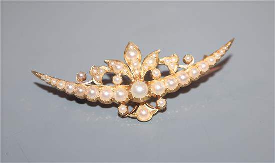 A yellow gold and split pearl set foliate crescent brooch, 54mm.